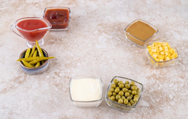 Assorted dressings and toppings on marble surface