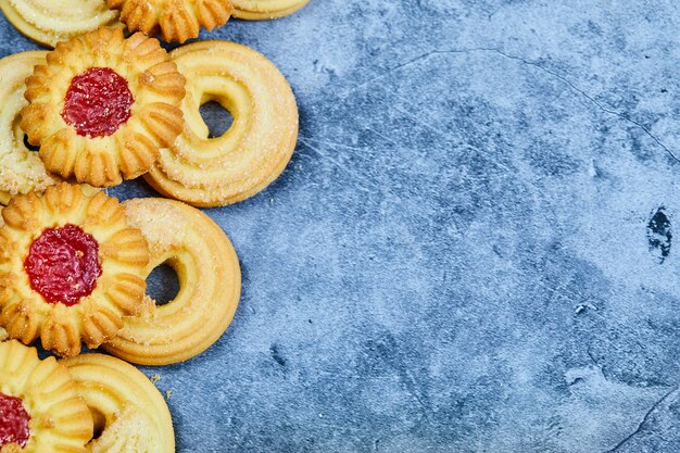 Assorted homemade biscuits on a blue background.