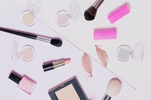 Assorted makeup supplies on light background