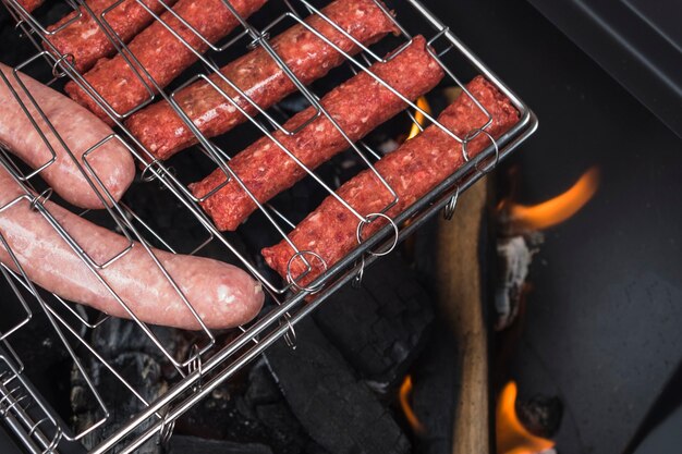 Assorted meat sausages on flaming grill