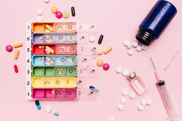 Assorted medications on pink