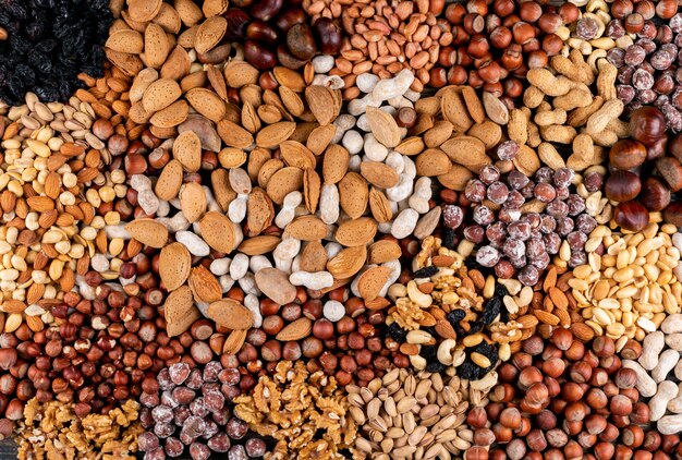 Assorted nuts and dried fruits with pecan, pistachios, almond, peanut, cashew, pine nuts top view