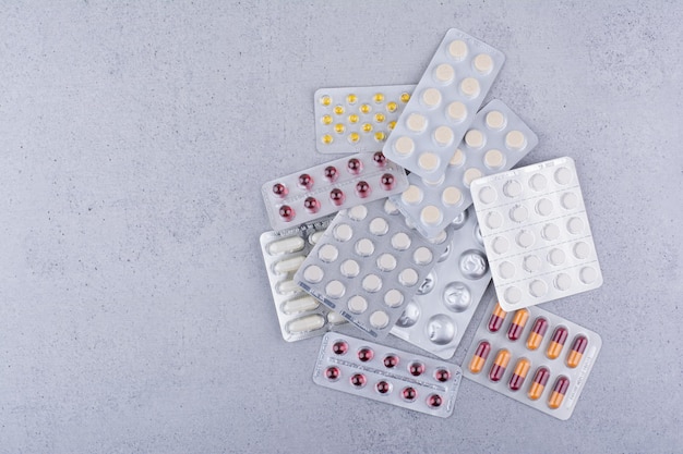 Assorted packs of medical drugs on marble background. High quality photo