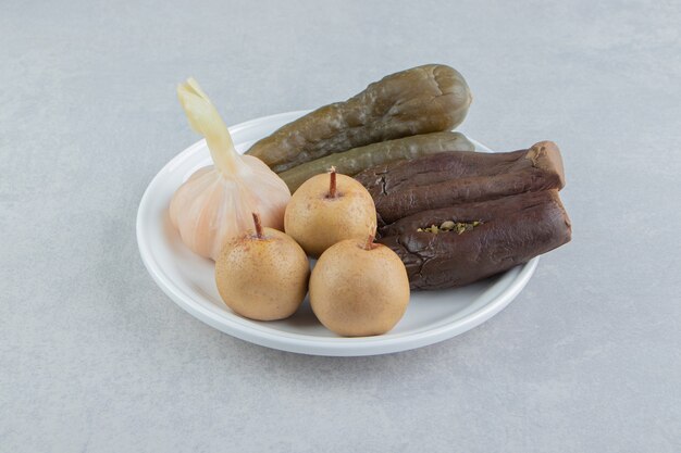 Assorted pickles placed on white plate