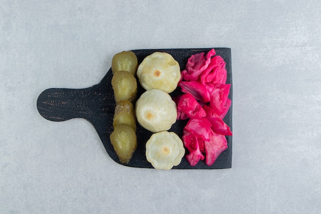 Free photo assorted salty vegetables on black board.