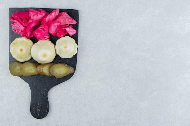 Free photo assorted salty vegetables on black board.