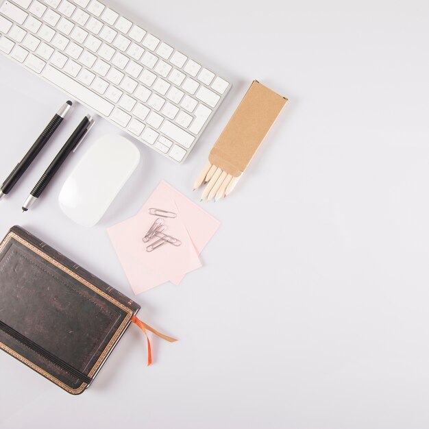 Assorted stationery near new keyboard and mouse