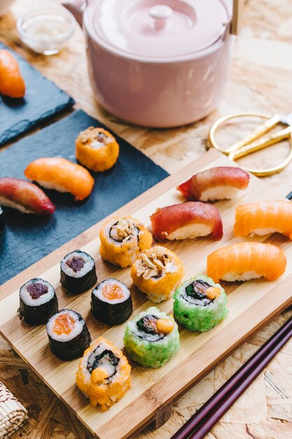 Assorted sushi near teapot