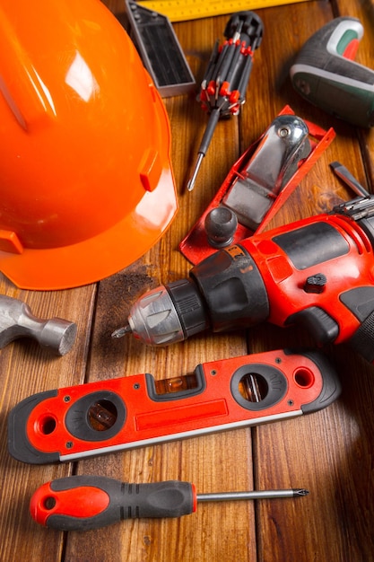 Assorted work tools on wood background