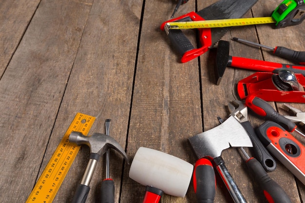 Assorted work tools on wood background