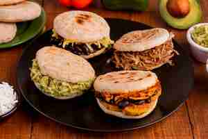 Free photo assortment of arepas with filling on plate