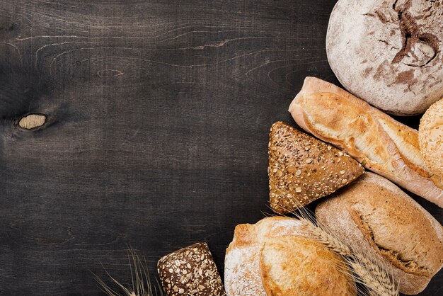 Assortment of baked bread on wooden background
