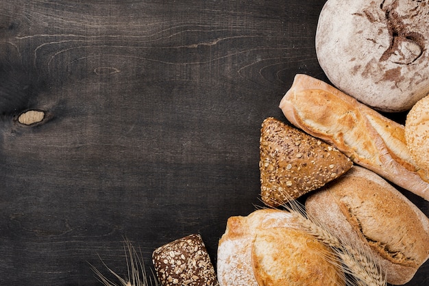 Assortment of baked bread on wooden background