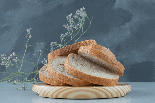 Assortment of bread slices on wooden plate