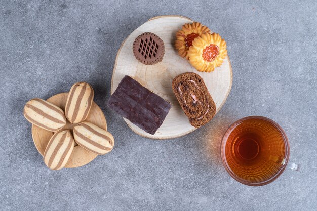 Assortment of cakes and cookies and a cup of tea 