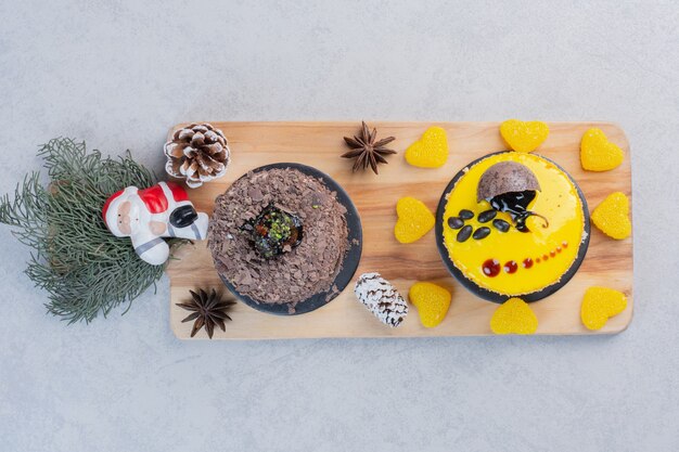 Free photo assortment of cakes on wooden board with santa.