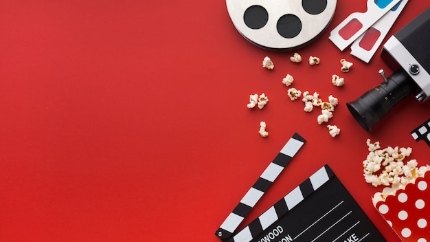 Assortment of cinema elements on red background with copy space
