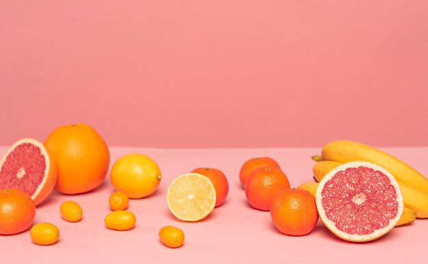 Assortment of citruses on pink table