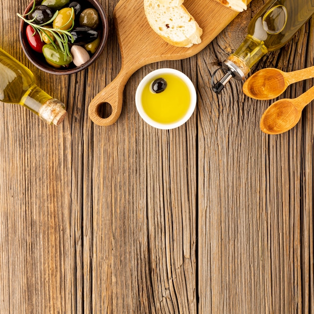 Assortment of colorful olives with oil saucer bread and copy space