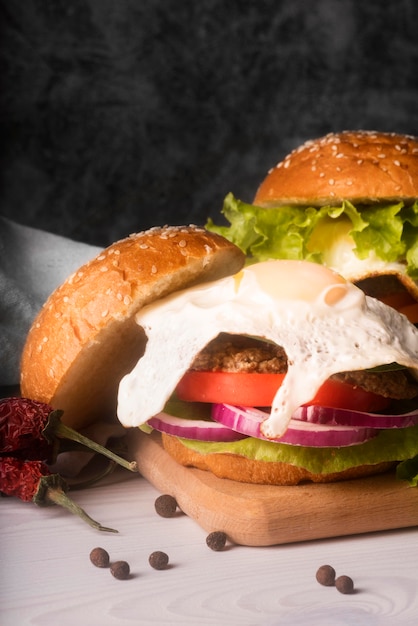 Assortment of delicious hamburgers on white table