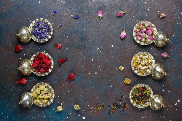 Assortment of dry tea in golden vintage mini plates.Tea types