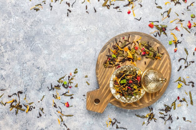 Assortment of dry tea in golden vintage mini plates. Tea types