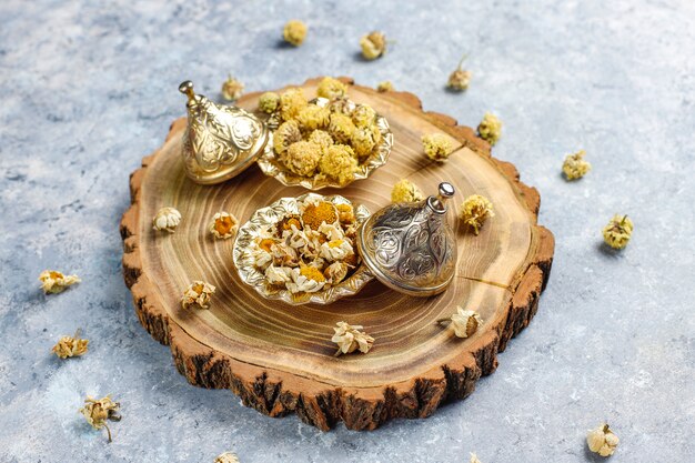 Assortment of dry tea in golden vintage mini plates. Tea types