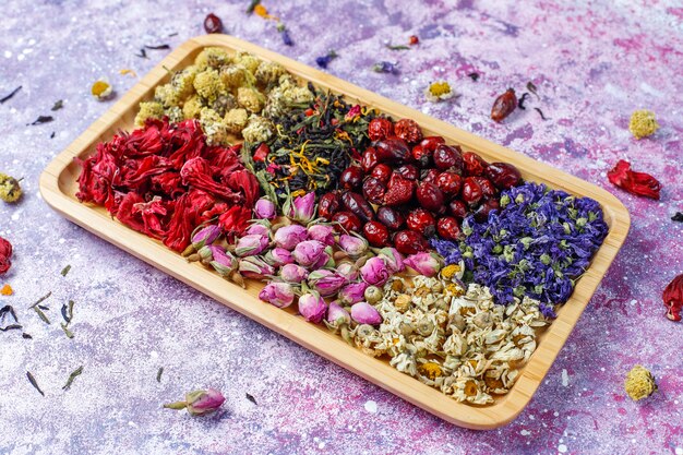 Assortment of dry tea in golden vintage mini plates. Tea types