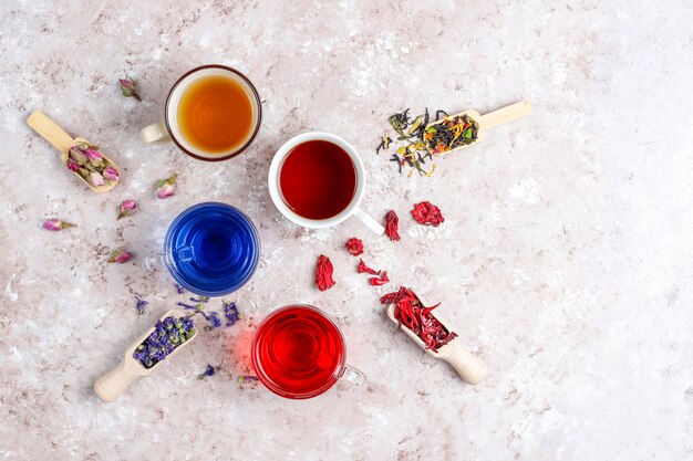 Assortment of dry tea in golden vintage mini plates. Tea types