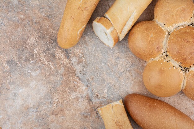 Assortment of fresh bread on marble background