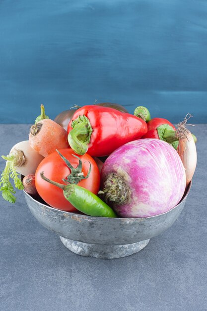 Assortment of fresh vegetables in iron bucket.