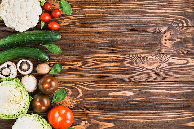 Assortment of fresh vegetables on wooden table