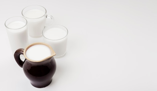 Assortment of glasses and cup of milk with copy space