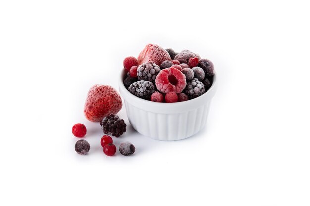 Assortment of iced berries in a bowl isolated on white background