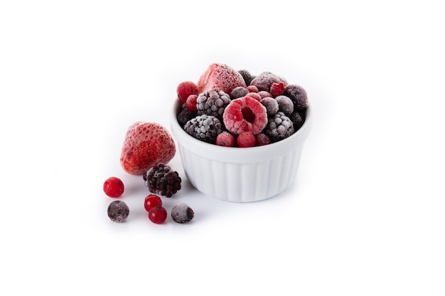 Assortment of iced berries in a bowl isolated on white background