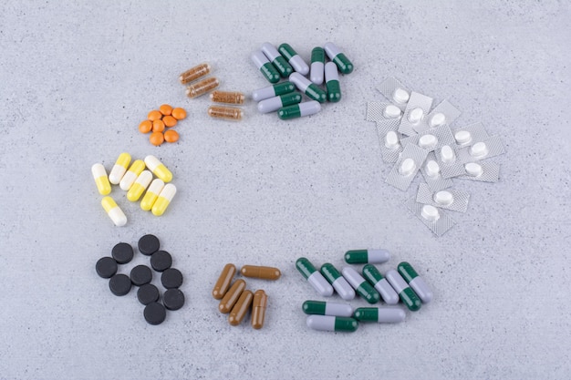 Assortment of medical drugs on marble background. High quality photo