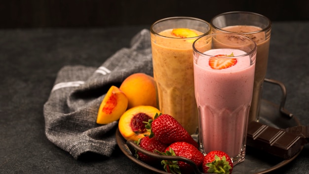 Assortment of milkshake glasses with fruits and chocolate