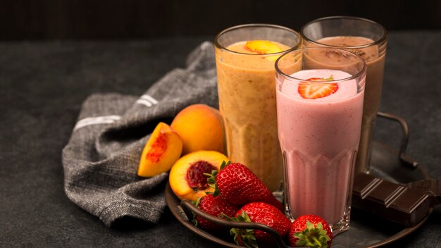 Assortment of milkshake glasses with fruits and chocolate