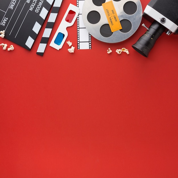Assortment of movie elements on red background with copy space