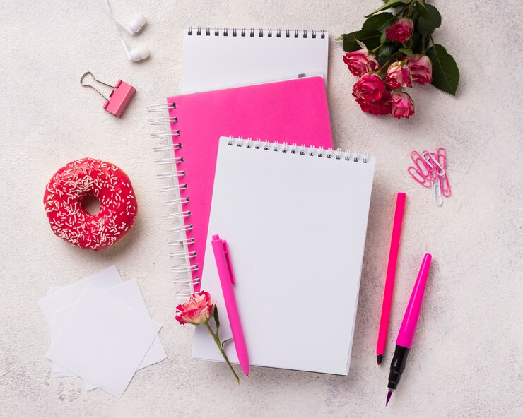 Free Photo assortment on notebooks with doughnut and bouquet of roses
