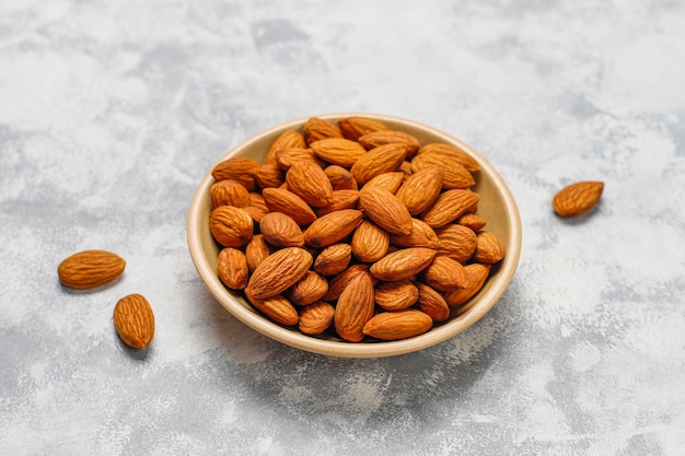 Assortment of nuts in ceramic plates. Cashew, hazelnuts, walnuts, pistachio, pecans, pine nuts, peanut, raisins.top view