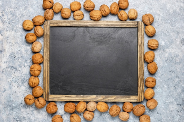 Assortment of nuts on concrete surface.Hazelnuts, walnuts, pecans, peanut,almonds,top view