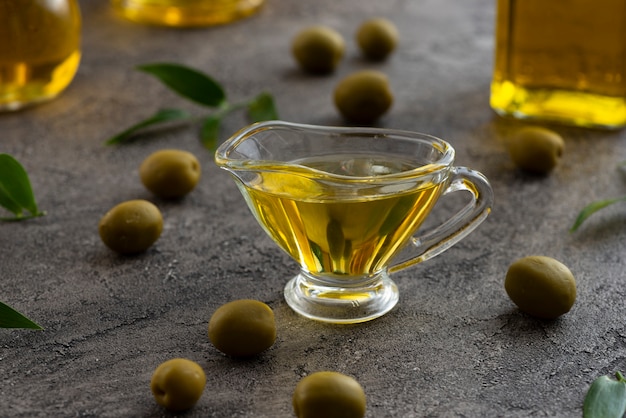 Assortment of olive oil in glass and green olives