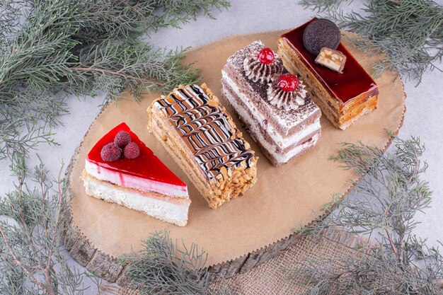 Assortment of pieces of cakes on wooden piece. High quality photo