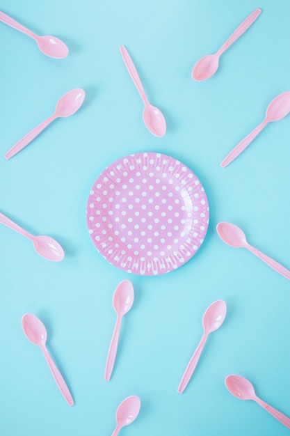 Assortment of pink plastic spoons and plate