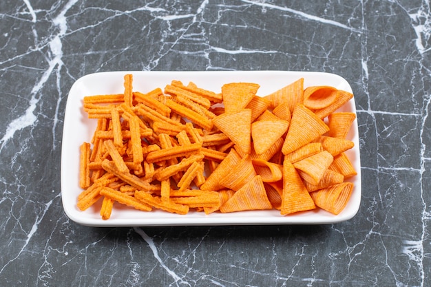 Free photo assortment of spiced chips on white plate.