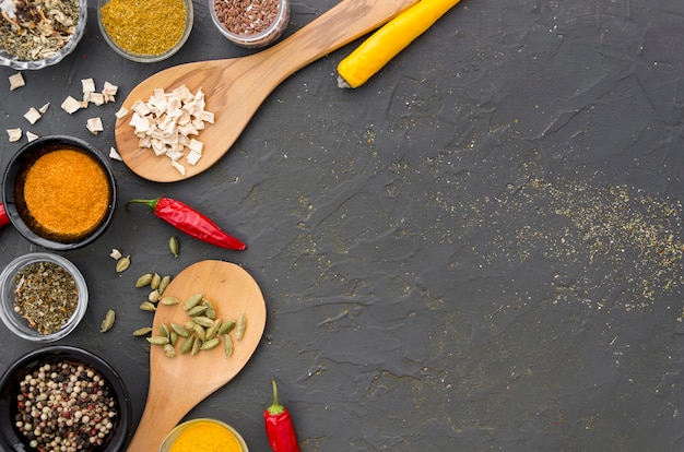 Assortment of spices and herbs on a grey copy space background