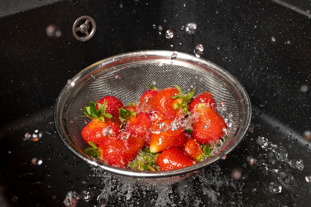 Assortment of strawberries being washed