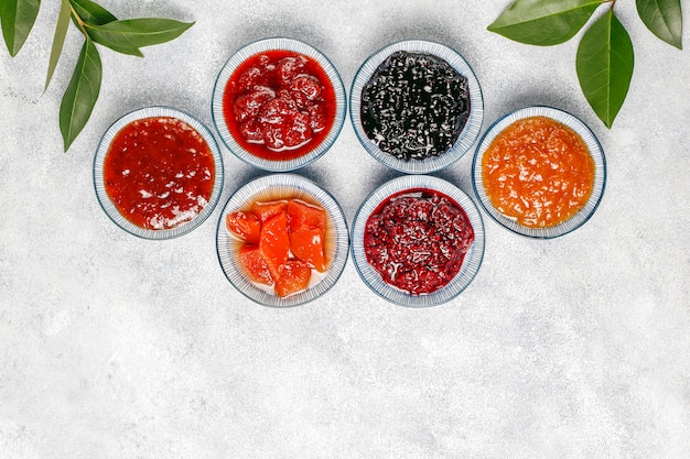 Assortment of sweet jams and seasonal fruits and berries