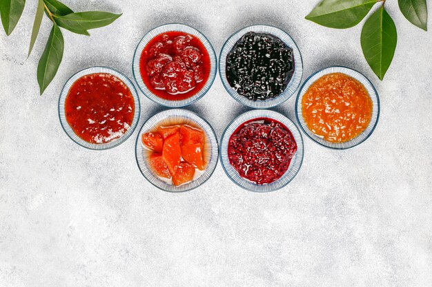 Assortment of sweet jams and seasonal fruits and berries